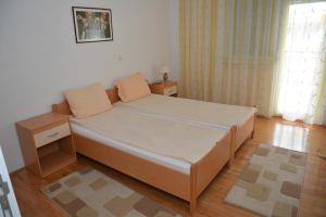 a small bedroom with a bed with two night stands at ASP Apartments in Ohrid