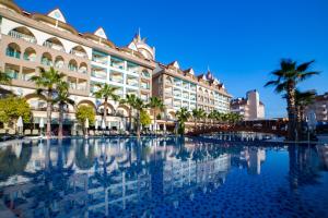 a large building with a pool in front of it at Side Crown Palace Ultra All Inclusive in Side