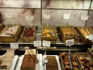 
a display case filled with lots of different types of pastries at Hotel AR Golf Almerimar in Almerimar
