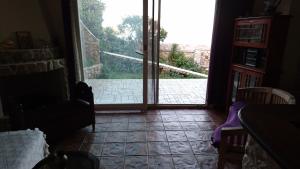 a room with a door leading to a patio at Το πετρινο in Agia Marina Mikrolimanou