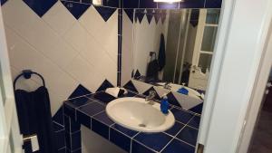 a blue and white bathroom with a sink and a mirror at Το πετρινο in Agia Marina Mikrolimanou +22 photos