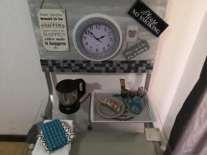 un reloj y otros artículos en un estante en Doedoe Plekkie, en Rustenburg