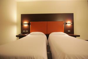 Postel nebo postele na pokoji v ubytování Hotel Major
