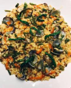 a white plate of food with rice and vegetables at Hotel Montiruju in Santa Maria Coghinas