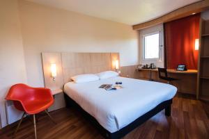 a hotel room with a bed and a red chair at Ibis Château-Thierry in Essômes-sur-Marne +96 photos