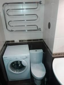 a small bathroom with a toilet and a sink at ApartamentKievVinogradar in Kyiv