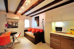 a small living room with a couch and a table at Palace La Vida Apartments by Wonderful Italy in Venice +31 photos