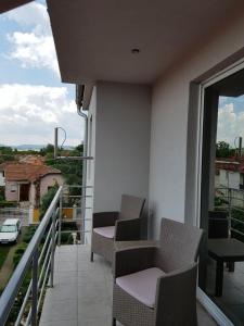 a balcony with chairs and a view of a city at Blue point in Kragujevac