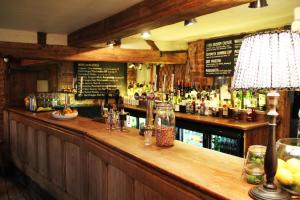 a bar with a lot of bottles of alcohol at Bel and The Dragon-Cookham in Cookham
