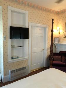 a hotel room with a bed and a television at Central House Inn in Bar Harbor
