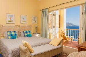 een slaapkamer met een bed en uitzicht op de oceaan bij Albatross Guest House in Simonʼs Town