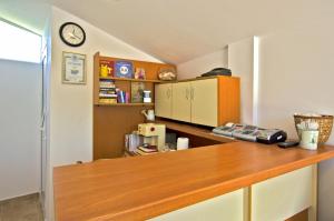 a kitchen with a wooden counter and a refrigerator at Di Mare Holiday Village in Kranevo