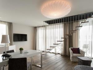 a living room with a white table and a staircase at Hotel-Restaurant-Schifflände in Birrwil