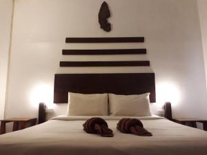 מיטה או מיטות בחדר ב-Laos Haven Hotel