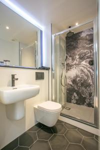 a bathroom with a sink and a toilet and a shower at Grafton Street Studios by City Break Apartments in Dublin