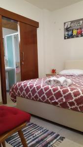 a bedroom with a bed with a giraffe blanket at Marina's Rooms in Larnaca