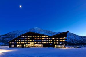 a building in the snow with the moon in the sky at Myrkdalen Resort Hotel in Myrkdalen