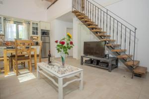 a living room with a vase of flowers on a table at Alexandros Stone House in Nydri