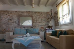 a living room with two couches and a table at Ergina Summer Resort in Antiparos