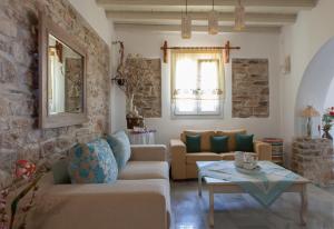 a living room with a couch and a table at Ergina Summer Resort in Antiparos