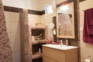 a bathroom with a sink and a brick wall at Ergina Summer Resort in Antiparos