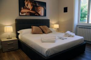 a bedroom with a large bed with a picture on the wall at Nomentana House in Rome