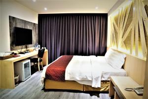 Voodi või voodid majutusasutuse Dahshin Hotel toas