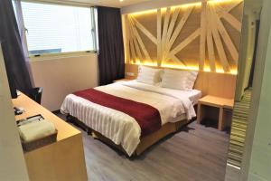 Voodi või voodid majutusasutuse Dahshin Hotel toas