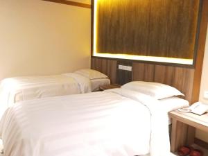 Voodi või voodid majutusasutuse Dahshin Hotel toas