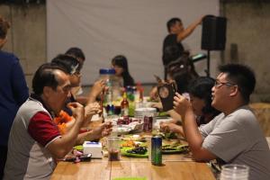 a group of people sitting at a table eating food at dric's House in Tanjungpandan +18 photos