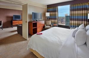 a hotel room with a large bed and a television at Crowne Plaza Kansas City Downtown, an IHG Hotel in Kansas City