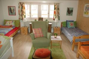 a living room with a couch and a chair at Chalet la Griotte in Villars-sur-Ollon