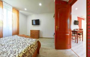 a bedroom with a bed and a sliding door at Private Apartments in Truskavets