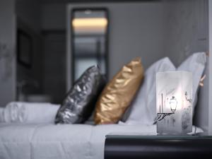 a bed with pillows and a bag on top of it at Solar Antigo Porto Aeroporto in Maia