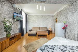 a living room with a couch and a refrigerator at Kamchatka Guest House in Anapa