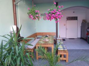 a dining room with a table and chairs and flowers at Penzion Netolice in Netolice