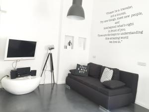 a living room with a couch and a tv at Mini Loft Design in Budapest