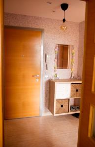 a bathroom with a wooden door and a sink at Apartamento Retamar in Retamar