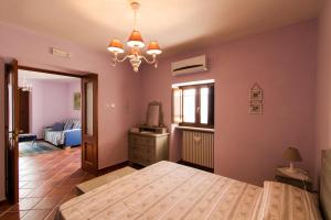 a bedroom with a large bed in a room at La Rossa Fantastica in Piedimonte dʼAlife