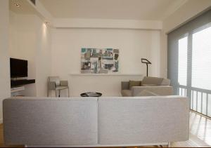 a living room with a couch and a tv at App-Arte Marseille Vieux-Port in Marseille