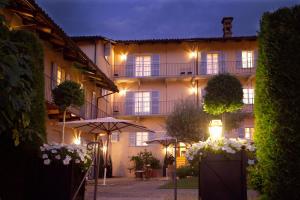 a building with an umbrella in front of it at night at Corte Gondina Boutique Hotel in La Morra