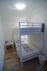 a bedroom with two bunk beds in a room at Traditional Piran house in Piran