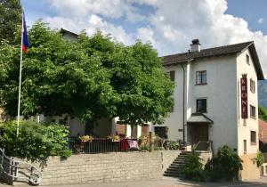 a house with a tree in front of it at Bed and Breakfast Krone in Schellenberg