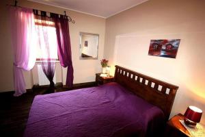 a bedroom with a purple bed and a window at Villa Violica, Karnevali in Žminj +16 photos