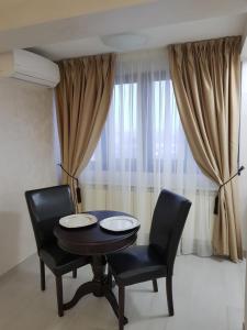 una sala da pranzo con un tavolo e due sedie di Apartament Panoramic a Galaţi