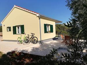 two bikes parked in front of a house at Happy garden house in Kožino