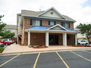 a building with a parking lot in front of it at Studio 6-Hampton, VA - Langley AFB Area in Hampton