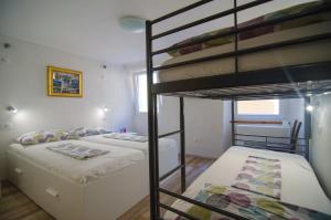 a bedroom with two bunk beds and a ladder at Traditional Piran house in Piran