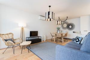 ein Wohnzimmer mit einem blauen Sofa und einem Tisch in der Unterkunft FLH Martim Moniz Luxus Flat in Lissabon