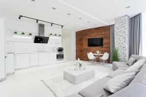 a white living room with a couch and a table at Prestige Plaza Apartments in Odesa